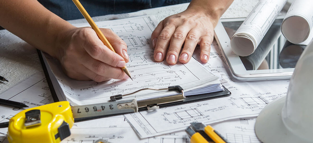 The building designer takes notes and sketches various concepts on the initial visit with the client. The measuring tape is used to check existing features in addition or renovation projects