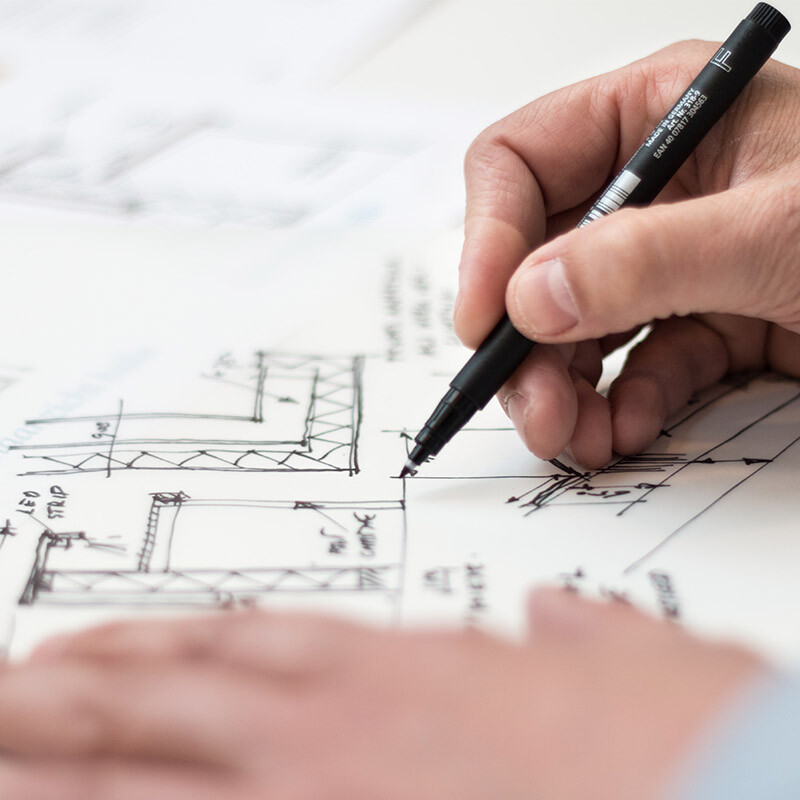 During the first meeting with a client, the Building Designer sketches ideas about the kitchen cabinetry to illustrate an idea for the client