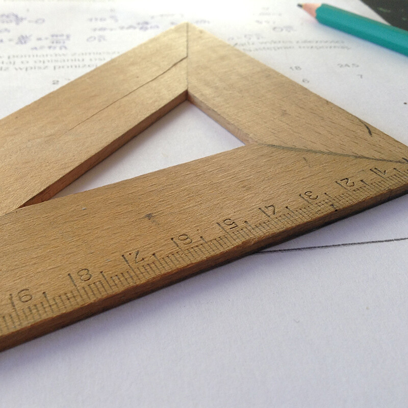 Sketching Equipment-Pen and Set Square. Traditionally, sketching is done freehand with pencil and paper. Here, a traditional wooden set square is shown.