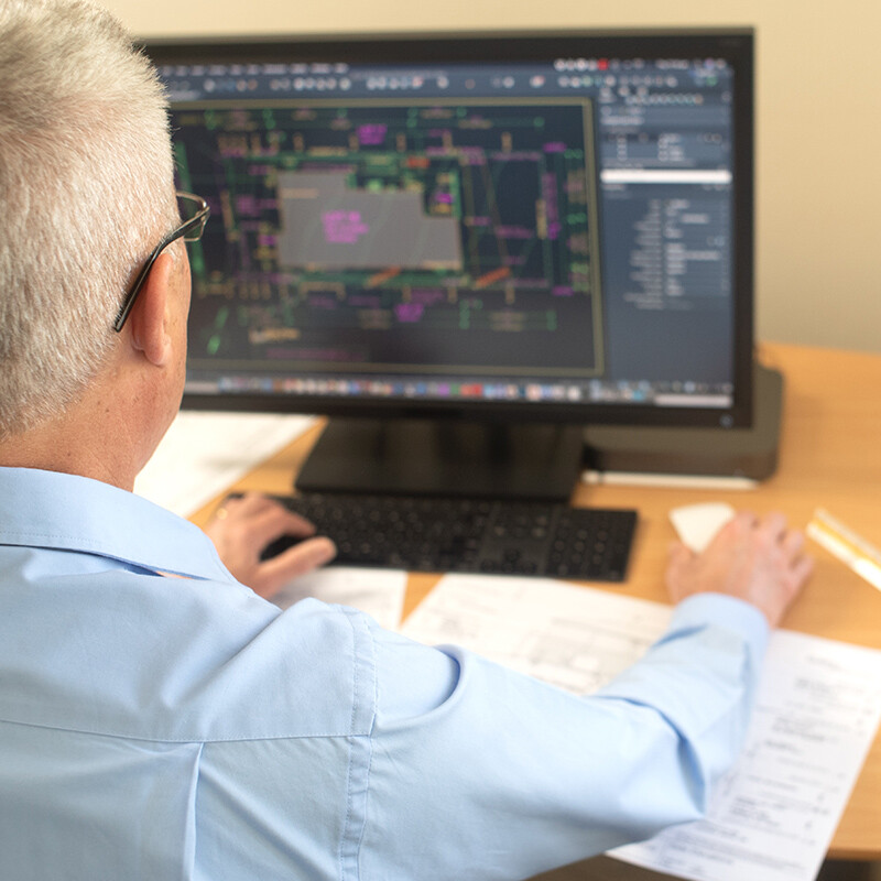 Drafting Architectural Site Plan Using AutoCAD. Designer/Draftsman working on Site Plan using AutoCAD on desktop computer